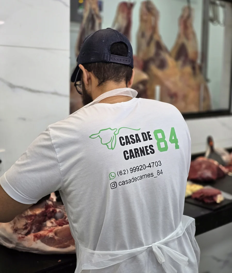 Açougueiro cortando carne no balcão
